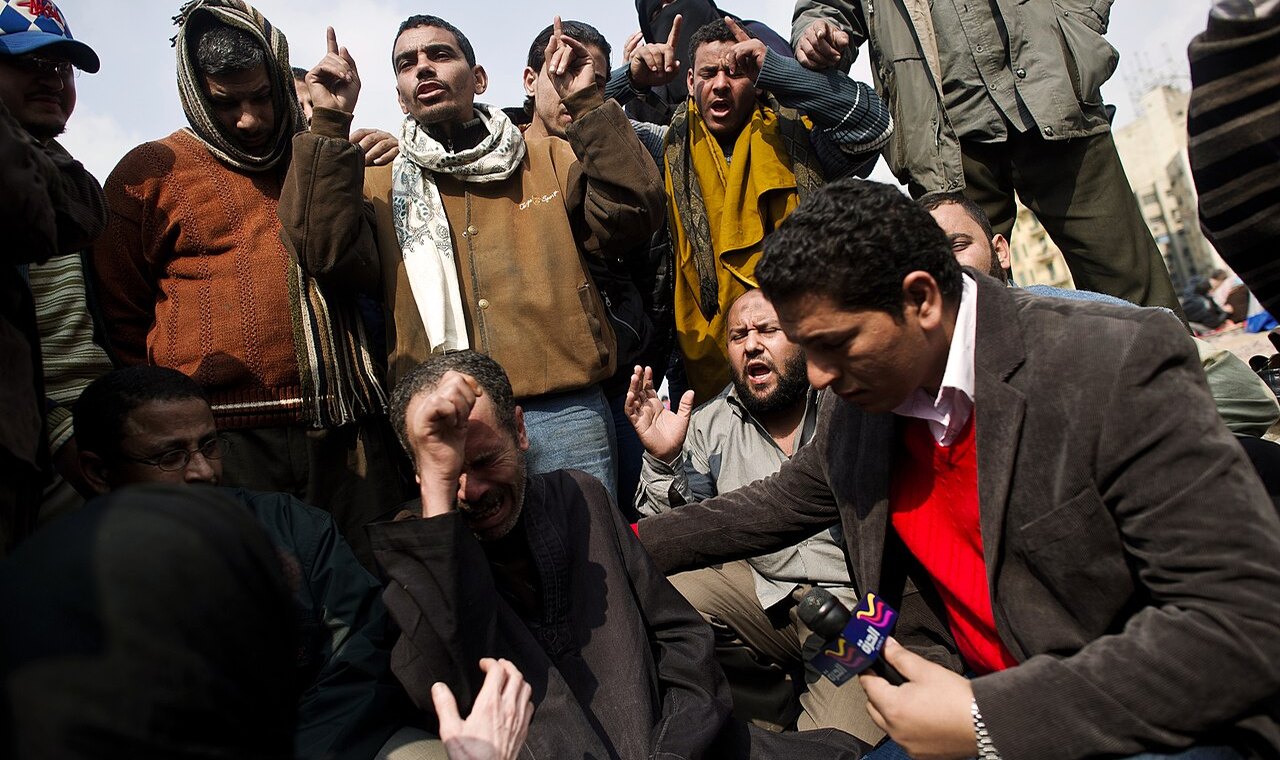 Reporter interviewing people in the field